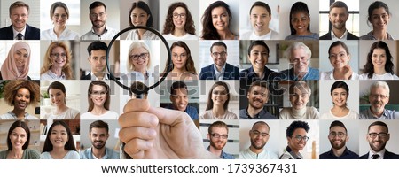 Employer hand holding magnifying glass choosing old middle aged female candidate among young multiethnic professional people faces collage. Human resource, headhunting, senior job opportunity concept.