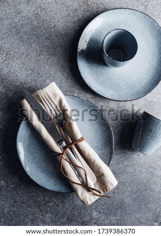 Served table setting with food blue ceramic set. Minimalist style, top view.