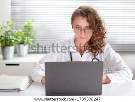 portrait of female doctor working on laptop telemedicine concept Royalty-Free Stock Photo #1739398247