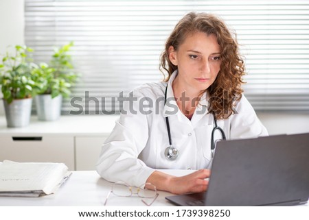 portrait of female doctor working on laptop telemedicine concept Royalty-Free Stock Photo #1739398250