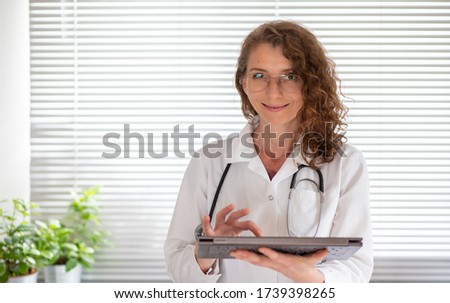 portrait of female doctor working on laptop telemedicine concept Royalty-Free Stock Photo #1739398265
