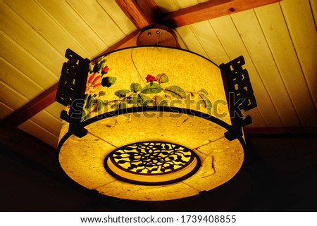 Close up of beautiful vintage chinese style paper lantern on the ceiling at night