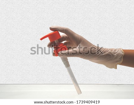Design ideas Closeup pump in the hand with rubber gloves clipping path