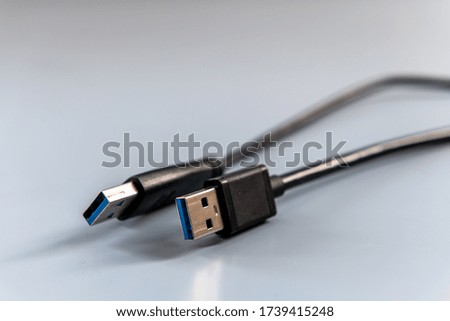 USB cables. Isolated image with a grey background. Available in many different types for connecting electronic devices especially in computing.