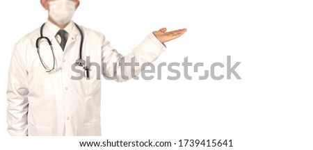 Male doctor standing in white background, showing something with his hand with a stethoscope around his neck in a white coat.