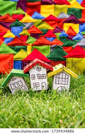 Colorful houses over color background and green grass