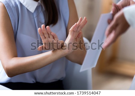 Close up of incorrupt female employee reject taking envelope with illegal money or bribe, honest woman worker deny decline cash reward from boss or business partner, bribery, corruption concept Royalty-Free Stock Photo #1739514047