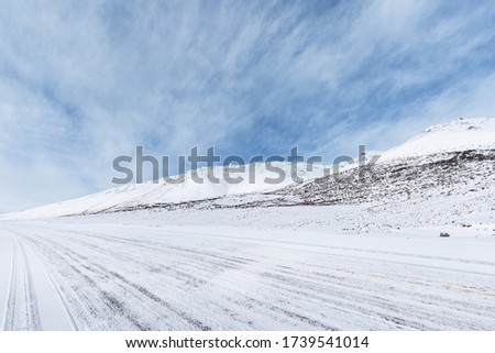 road on snow area plateau, snow covered the national highway in Tibet, China Royalty-Free Stock Photo #1739541014