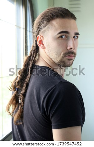Stylish male model with braids posing. Style, hairstyle, fashion concept.