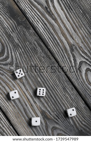 Dices are white with black dots. On brushed pine boards.