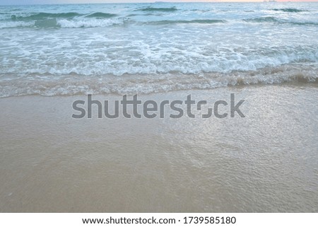Clean waves on the sea beach with white bubbles for background texture 