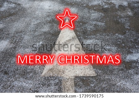 Merry Christmas card concept for greeting. Old traffic sign on an asphalt road in the form of a Christmas tree.