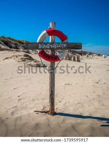 sign at borkum beach lifebuoy