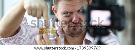Disheveled man camera takes his attitude alcohol. Unbearable life with an alcoholic. Man provokes his behavior by shooting himself on camera. Personality degradation. Adult behaves inappropriately
