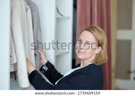 a woman chooses clothes on a rack in a showroom. boutique