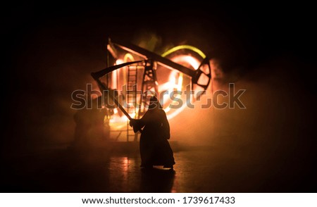 Oil industry crisis concept. Oil stock crisis because Covid global pandemic. Oil pump and oil refining factory at night with fog and backlight. Creative artwork decoration. Selective focus.