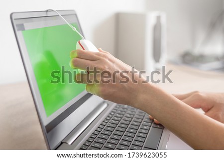 Photographer women hand use calibrate tool check color of monitor on computer laptop monitor inspection concept before Image work 