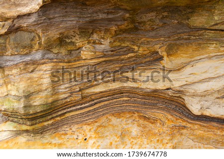 These Jurassic sedimentary rocks show an shallow marine environment in constant change not allowing the deposits to accumulate to any great depth and typical of the cliff rocks on the Dinosaur Coast Royalty-Free Stock Photo #1739674778
