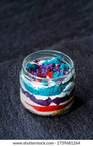 Rainbow Cake Dessert in Glass Jar Flavored with Dragee and Fruits.