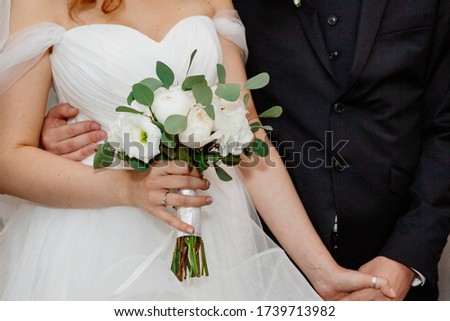 Elegant wedding bouquet with white and pink flowrs in bride's hands