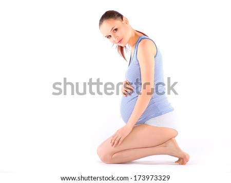 Beautiful pregnant woman making yoga