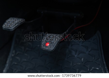 Close up of an additional brake pedal of a driving test vehicle for the practical driving test