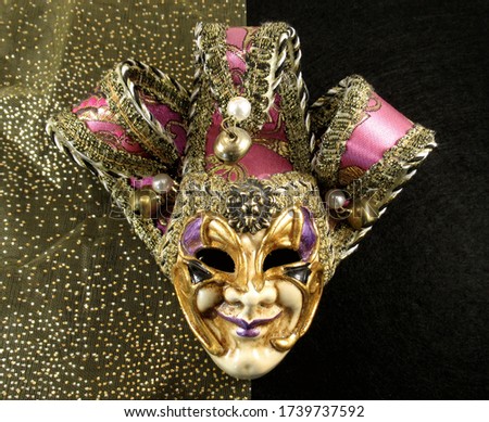 Venetian carnival mask on a golden sparkling and black background