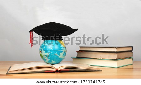 World globe on text book.Graduate study abroad programs. International education school Concept.  Congratulations on graduating Royalty-Free Stock Photo #1739741765