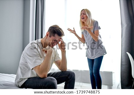 portrait of young caucasian woman chastising husband for his antics, bad behavior, unhealthy relationships, problems in family Royalty-Free Stock Photo #1739748875
