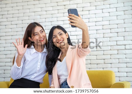 Happy beautiful young asian woman friendship selfie together , Happiness teenagers taking pictures selfie in living room