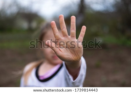 Girl making stop gesture with hand. Social distancing, quarantine, self-isolation, lifestyle concept.