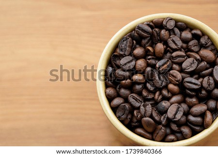 Close up of coffee beans in a cup, space for text. 