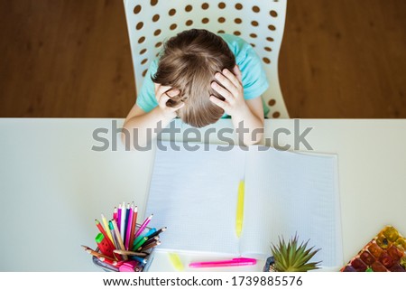 Cute little boy painting with color pencils at home, in kindergaten or preschool. Creative games for kids staying at home