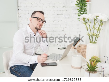 Business man using laptop and smartphone at home. Freelance or distance study concept