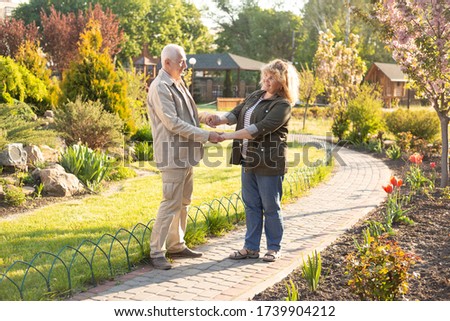 Happy old elderly caucasian couple smiling in park on sunny day, senior couple relax in spring summer time. Healthcare lifestyle elderly retirement love couple together valentines day concept