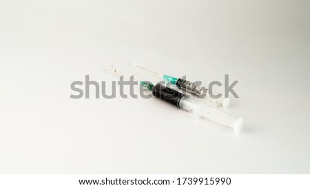 syringes standing side by side on white background