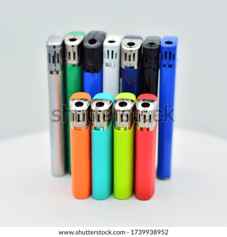 Colored lighters standing on white background