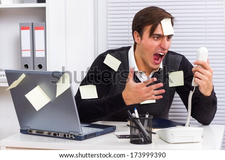 Businessman shouting on telephone at his office,Frustrated businessman Royalty-Free Stock Photo #173999390