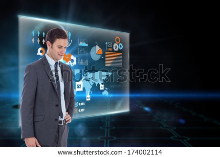 Smiling businessman with hand on hip against keyhole on technological black background