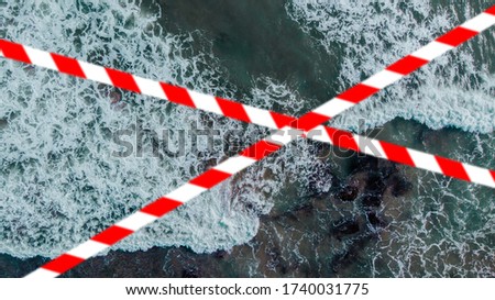 Barrier tape - quarantine, isolation, entry ban. Do not cross. Top view of the sea shore