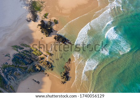View from above of empty beach with rocks. Seaside vacation turism. Holidays by the beach	 Royalty-Free Stock Photo #1740056129