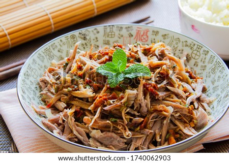 Shredded chicken salad in a bowl close up Royalty-Free Stock Photo #1740062903