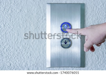 Using hands, press the elevator up and keypad elevator