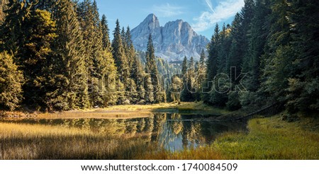 Awesome alpine highlands in sunny day. Mountain landscape, picturesque mountain lake in the summer morning with perfect sky, picture of Wild area. Stunning Natural Background. Creative image 