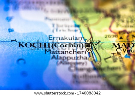 Shallow depth of field focus on geographical map location of Kochi Cochin city in Kerala India Asia continent on atlas
