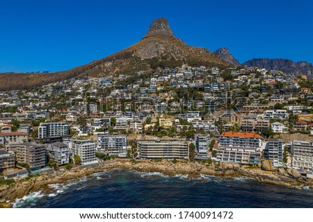 Aerial photograph of the coastal suburbs of Bantry Bay and Clifton, with Lions Head and Table Mountain in the Background