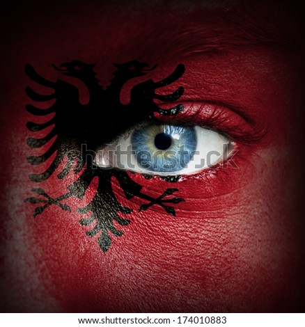 Human face painted with flag of Albania
