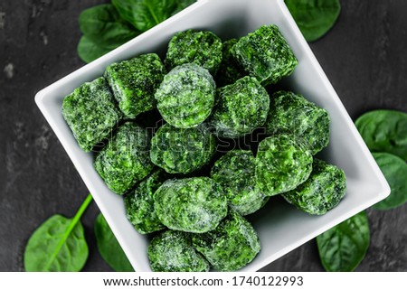 Frozen spinach cubes as detailed close up shot (selective focus) Royalty-Free Stock Photo #1740122993