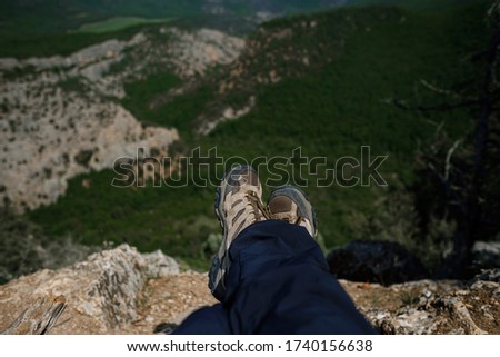 Summer time mountain nature panoramic landscape. Hikers trekking boots at foreground. enjoying vacation travel adventure