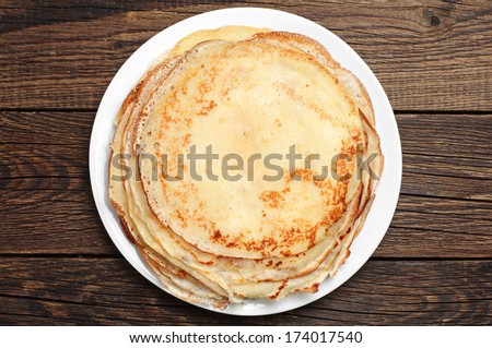 Fried pancakes on old wooden table. Top view Royalty-Free Stock Photo #174017540